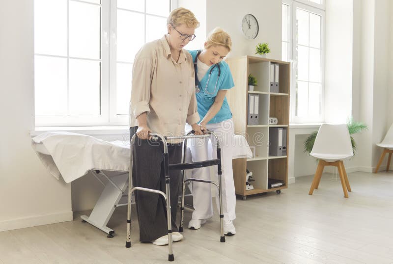 Nurse helping a senior patient walk during rehabilitation